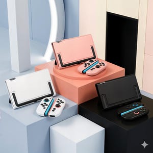 May include: A collection of gaming console accessories, including cases and controllers, in various colors. The cases are in pink, white, and black, with black accents. The controllers are in matching colors with blue and pink accents. The items are displayed on geometric blocks.