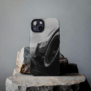 May include: A white ceramic mug with a black handle and the text "But First, Coffee" in a handwritten style. The mug is on a white surface. The mug is approximately 4 inches tall.