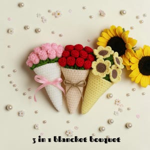 May include: Three crochet bouquets in white, beige, and yellow cones, each holding different flowers: pink roses, red roses, and yellow sunflowers. The bouquets are tied with ribbons and twine. The text "3 in 1 blanket bouquet" is at the bottom.
