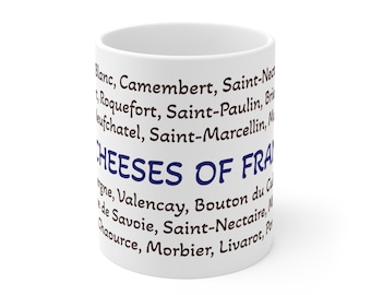 May include: White ceramic mug featuring a list of French cheeses in a dark blue font. The words "CHEESES OF FRANCE" are prominently displayed in the center of the mug.