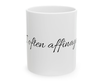 May include: White ceramic coffee mug with the handwritten text "I often affinate" in black script. The mug is cylindrical and has a simple, clean design, suitable for hot or cold beverages.