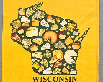 May include: A yellow rectangular kitchen towel featuring a dark green outline of the state of Wisconsin filled with various illustrations of cheese wedges, blocks, and crumbles. The word WISCONSIN is printed in black capital letters below the map.