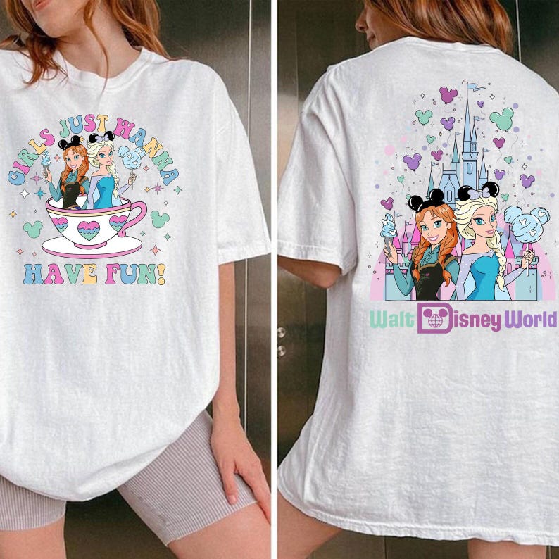 May include: White t-shirt featuring a colorful graphic of Anna and Elsa from Frozen, with the text "GIRLS JUST WANNA HAVE FUN!" on the front. The back of the shirt has a castle graphic and the words "Walt Disney World".