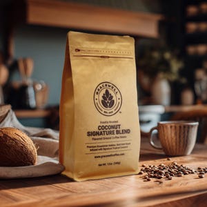 May include: A brown paper bag of Gracewell Coconut Signature Blend coffee sits on a wooden table. The bag features a logo and text, with a coconut and a cup of coffee nearby. The bag contains 12 oz (340g) of flavored ground coffee beans.