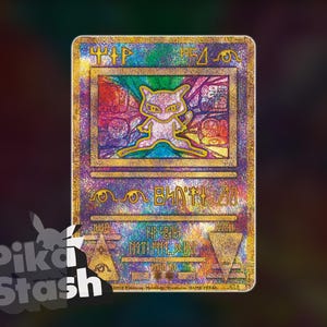 May include: A holographic trading card featuring a Mew character in a stained-glass style design. The card has a gold border and gold text. The background is a mix of purple, blue, and green colours. The card has the text "Pika Stash" in the lower left corner.