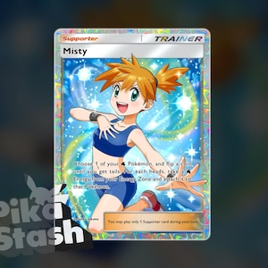 May include: A holographic Misty Trainer card from the Pokémon Trading Card Game. The card features an illustration of Misty in a blue outfit, with text that reads "Misty" and game instructions. The card has a silver border and a holographic background.