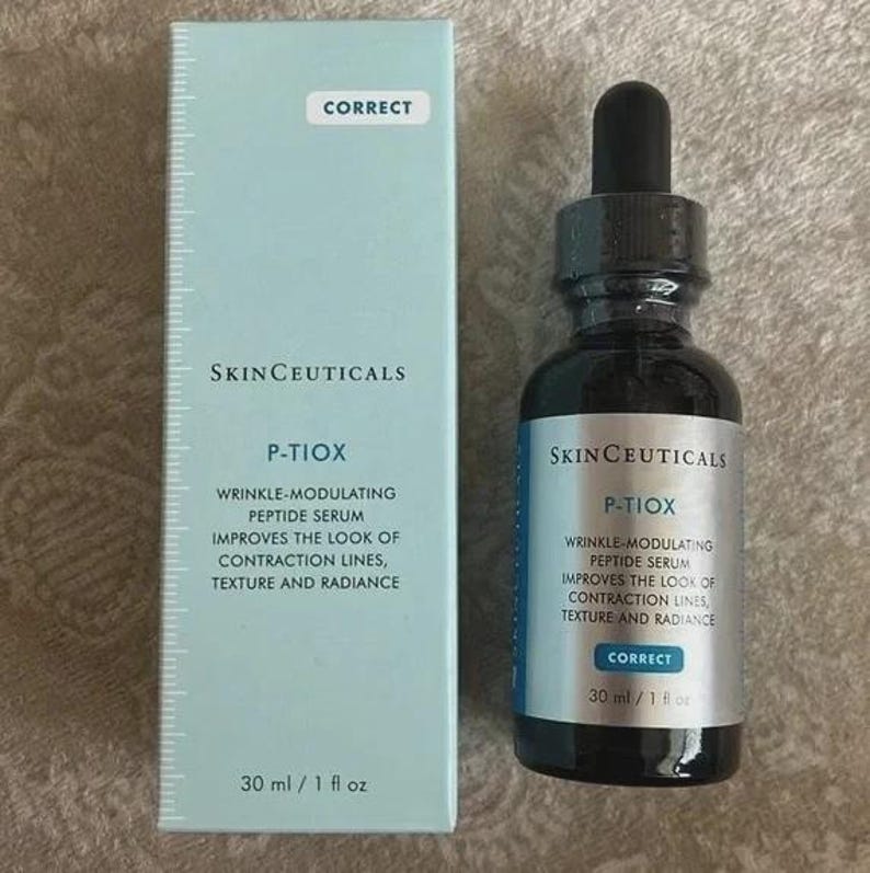 May include: A skincare product set featuring a dark glass bottle with a dropper and a light blue box. The bottle and box display the "SkinCeuticals" brand and "P-Tiox" wrinkle-modulating peptide serum. The box and bottle both read "Correct". The bottle contains 30 ml / 1 fl oz.