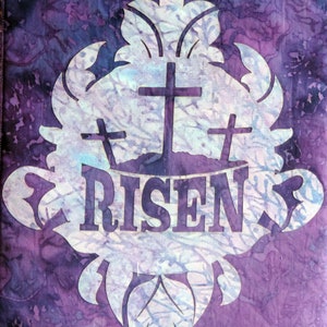 May include: Purple fabric with a white stencil design of three crosses and the word "RISEN".
