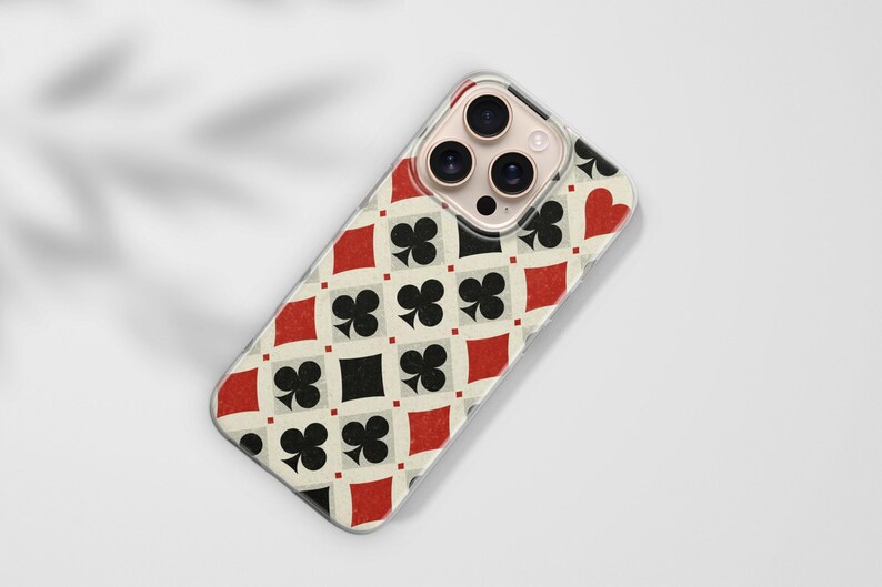May include: A phone case with a playing card design. The case features a repeating pattern of red diamonds, black clubs, black squares, and red hearts on an off-white background. The phone case has a clear border.