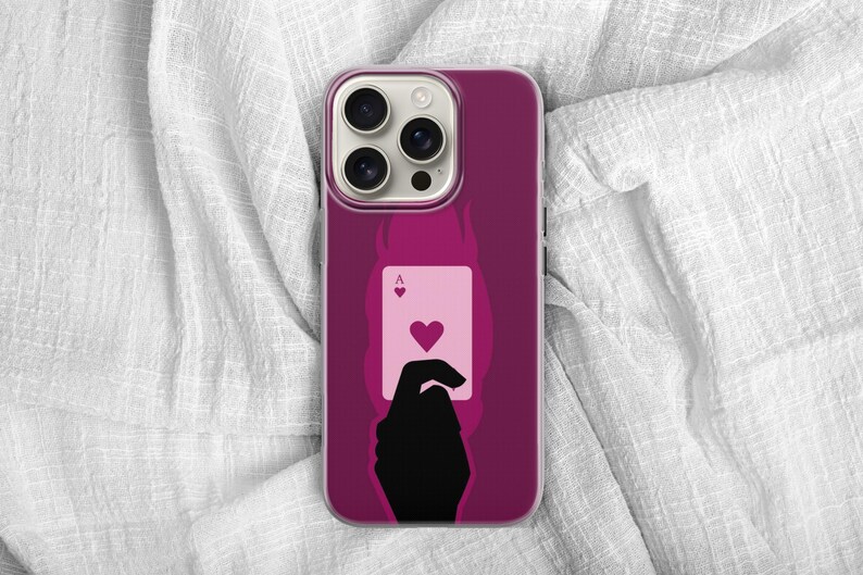 May include: A magenta phone case featuring a silhouette of a hand holding the Ace of Hearts playing card. The card is light pink with a red heart symbol. The case has a dark magenta background with a flame design.