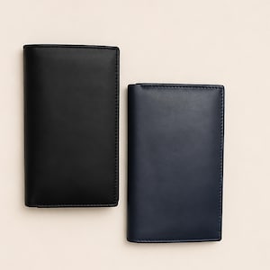 May include: Two leather wallets, one black and one navy blue, are displayed against a neutral background. The wallets are rectangular with rounded corners and stitched edges. The black wallet is taller than the navy blue one.