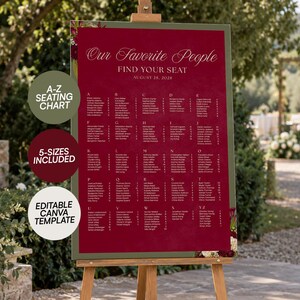 May include: A deep red wedding seating chart sign on a wooden easel with the text Our Favorite People, FIND YOUR SEAT, and AUGUST 28, 2028. The sign features an alphabetical list of names from A to Z and includes three circular text overlays.