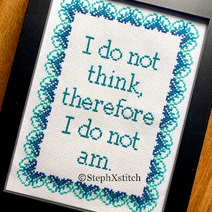 May include: Cross-stitch embroidery framed in black with a teal and blue border. The embroidery reads "I do not think, therefore I do not am." and is signed "StephXStitch".
