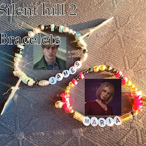 May include: Two beaded bracelets with images of characters from Silent Hill 2. One bracelet spells "JAMES" and the other "MARIA". The text "Silent Hill 2" and "Bracelets" are also visible.