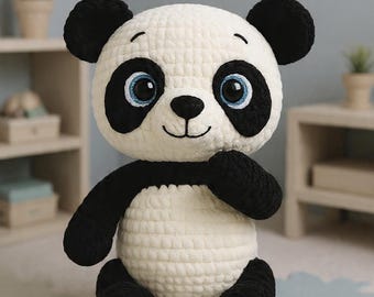 May include: A handmade crochet panda bear with black and white coloring. The panda has black ears, eyes, and limbs, with a white body. The panda has blue eyes and a smiling face. The stuffed animal is sitting on a light-colored rug.