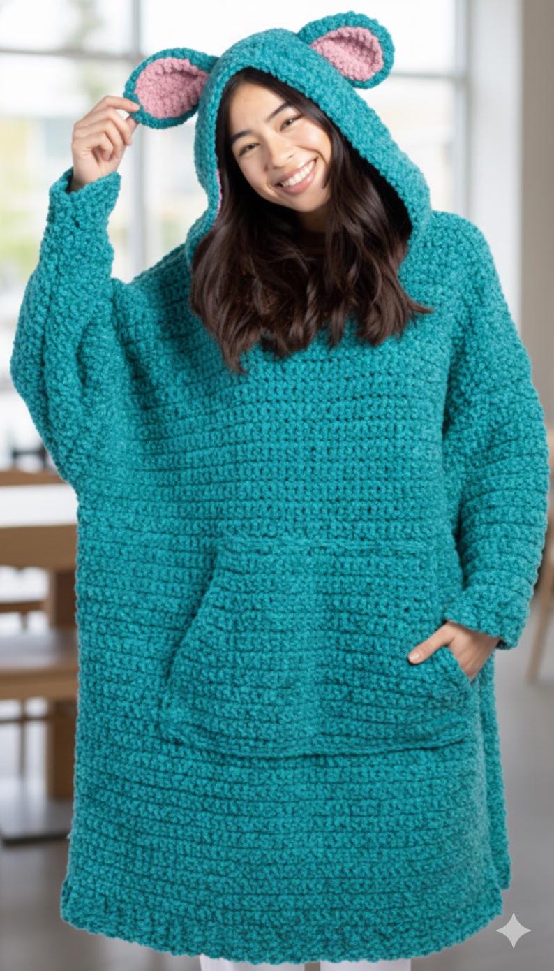 Puede incluir: Una manta con capucha de crochet turquesa con un bolsillo de canguro y una capucha con orejas rosas. La manta de gran tama&ntilde;o est&aacute; dise&ntilde;ada para ser usada, ofreciendo calidez y comodidad. Dise&ntilde;o acogedor y hecho a mano.