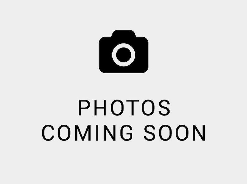 May include: A black camera icon above the text "PHOTOS COMING SOON" in a sans-serif font. The background is a light gray color. The image suggests that photos are not yet available.