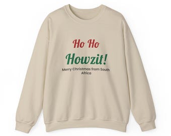 May include: A beige crewneck sweatshirt featuring the red text Ho Ho, the green text Howzit!, and the black text Merry Christmas from South Africa printed on the front. The garment has long sleeves, a ribbed neckline, and ribbed cuffs.