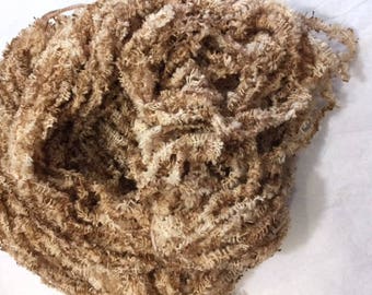 May include: A ball of brown and white yarn with a fluffy texture.