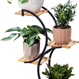 May include: A multi-tiered plant stand with four levels, featuring a black metal frame and natural bamboo shelves. Each shelf holds a different potted plant, showcasing a variety of greenery. The stand is designed to display plants indoors or outdoors.