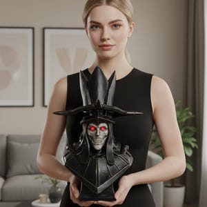 May include: A black bust of a skeletal figure with a tall, ornate hat and glowing red eyes. The bust has a detailed, textured surface and is held in front of a neutral background.