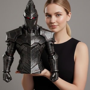 May include: A detailed, black knight bust with red eye accents. The armor features intricate geometric designs and a spiked helmet crest. The bust is held by a person against a grey backdrop, showcasing the craftsmanship and design.