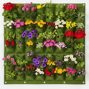 May include: A green vertical garden panel with an array of colourful flowers and plants. The panel features numerous pockets, each containing a different type of bloom, including red, pink, yellow, and white flowers, and green foliage. The panel is mounted on a white wall.
