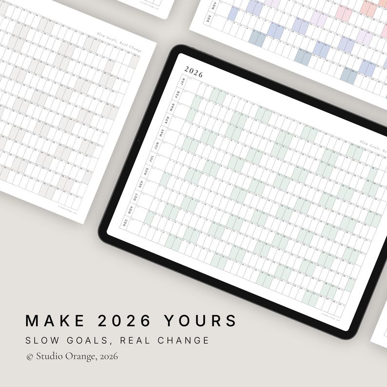 May include: A digital planner for 2026 on a tablet, featuring a monthly grid layout. The text "MAKE 2026 YOURS" and "SLOW GOALS, REAL CHANGE" is displayed below the tablet. The planner is designed to help organize goals and track progress.