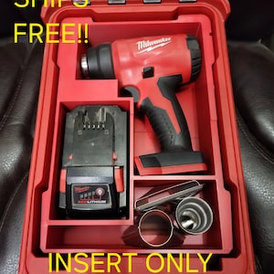 May include: Red Milwaukee heat gun and battery pack inside a red case. The case also contains several metal attachments. The text "INSERT ONLY NO TOOLS!" is visible on the case.