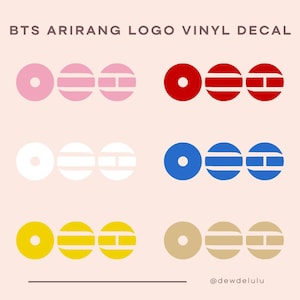 May include: Vinyl decals featuring the BTS Arirang logo in various color combinations: pink, red, white, blue, yellow, and tan. The logo consists of three circular shapes with horizontal lines and a central vertical line. Text at the top reads "BTS Arirang Logo Vinyl Decal."