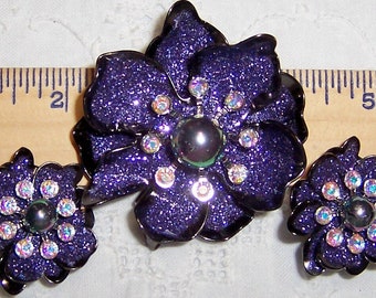 Vintage AB rhinestones, purple glitter and faux pearl brooch and earrings set. Gold and black metal. Signed Joan Rivers.