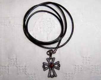 Vintage oxidized Cross with red orangey garnet and leather cord. Sterling silver.