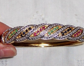 Vintage emeralds, rubies and sapphires bangle. Yellow gold over sterling silver. Ross Simons.