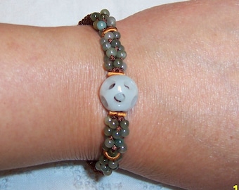 Vintage light green jade and green jade beads bracelet with brown and orange cord.