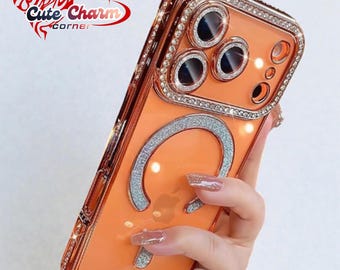 May include: An orange phone case with a sparkling silver accent and a ring of rhinestones around the camera and edges. The case has a glittery silver design and is held by a person.