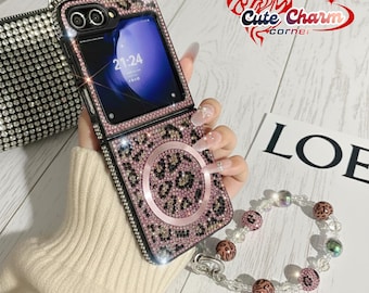 May include: A bedazzled pink and black leopard print phone case with a matching bracelet. The phone case is open, displaying the phone screen. The bracelet has clear beads and leopard print beads. The words "Cute Charm Corner" are in the upper right corner.