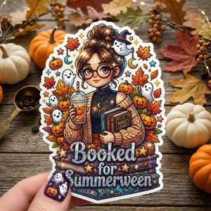 May include: A die-cut sticker featuring a person with glasses and a bun hairstyle holding an iced coffee and books. The design includes pumpkins, ghosts, autumn leaves, and the text "Booked for Summerween" over a stack of books with a magical theme.