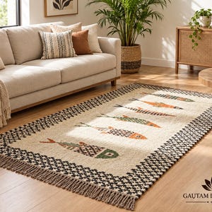 May include: A rectangular area rug featuring a cream-coloured centre with a repeating pattern of stylised fish in orange, green, and brown. The rug has a wide black and white checkered border and fringed edges on the short sides.