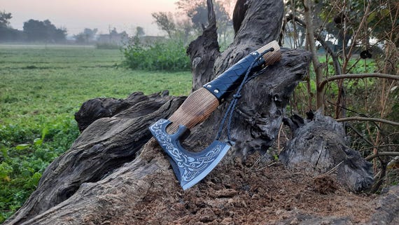 A hand-forged mini Viking axe that's small enough for EDC but carries serious 'this is an actual blacksmith's work' energy as a desk or camp piece.