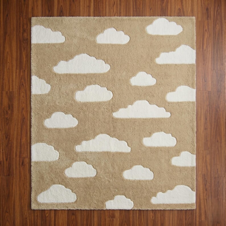 May include: A rectangular beige rug with white cloud cutouts. The rug has a soft, textured surface and is placed on a wooden floor. The cloud shapes are evenly spaced across the rug's surface.