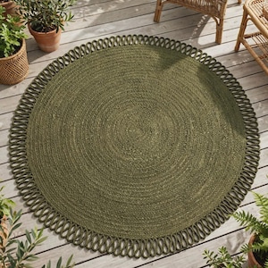 May include: A round, olive green rug featuring a braided centre and a decorative looped border. The rug is constructed from a textured, natural fibre material, showcasing a consistent circular weave pattern throughout the main body and edge.