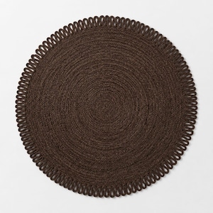 May include: A circular dark brown rug featuring a tightly woven centre and a decorative border composed of repeating, uniform loops. The rug has a consistent, textured appearance throughout, with the braided construction creating a radial pattern.