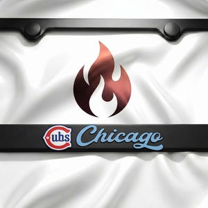 May include: Black license plate frame with the Chicago Cubs logo and a stylized flame graphic. The frame has a glossy finish and includes the team's logo in red, white, and blue.