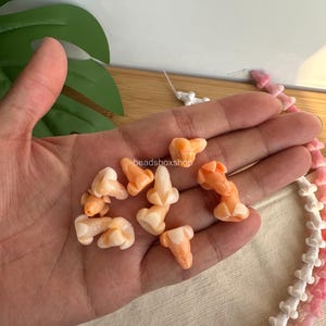 variegated orange puakenikeni flower beads