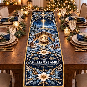 May include: A rectangular table runner featuring a dark blue background with a gold-bordered nativity scene, a star, and winter foliage. The text reads THE WILLIAMS FAMILY O Holy Night, surrounded by white poinsettia flowers and pine cones.