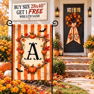 May include: A vertical garden flag featuring orange and white stripes, a central letter A framed by autumn leaves and pumpkins, and black bat silhouettes. A sign above reads: BUY SIZE 28x40" GET 1 FREE WREATH SASH. The flag includes spider web graphics.