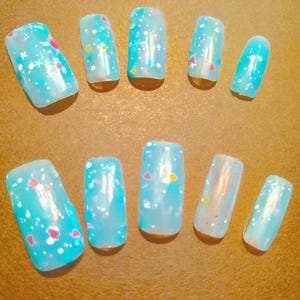 Light blue glow in the dark medium square nails.
