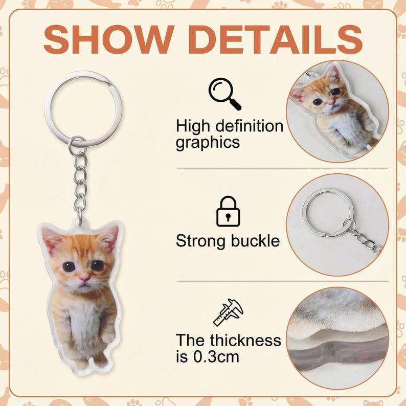 May include: A keychain featuring a detailed image of an orange tabby kitten. The keychain has a silver-colored ring and chain. The text "SHOW DETAILS" is at the top. The thickness of the keychain is 0.3cm.