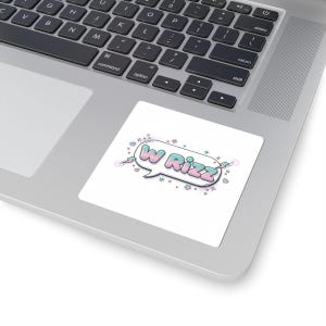 May include: A white sticker with the text "W Rizz" in a speech bubble. The text is in a gradient of blue and pink, with a white outline. The sticker is on a laptop.