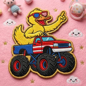 May include: Embroidered patch featuring a yellow duck wearing sunglasses and pointing. The duck is driving a red, white, and blue monster truck with large black tires. The patch is on a pink background with embroidered stars and clouds.